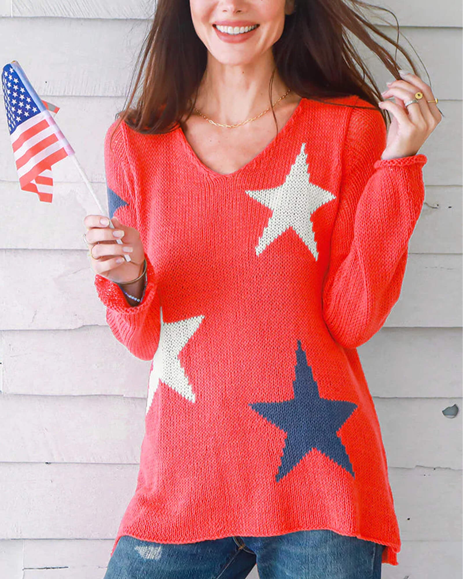 Model wearing red, white and blue star patterned sweater.